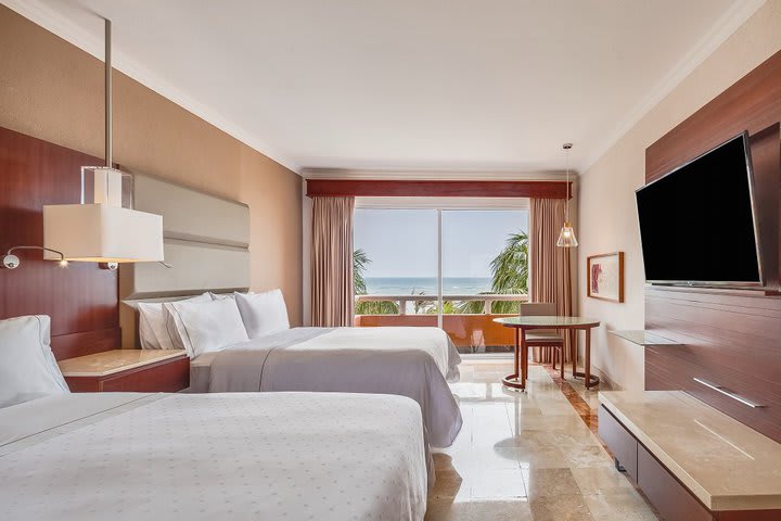 Deluxe guest room with two beds and ocean view