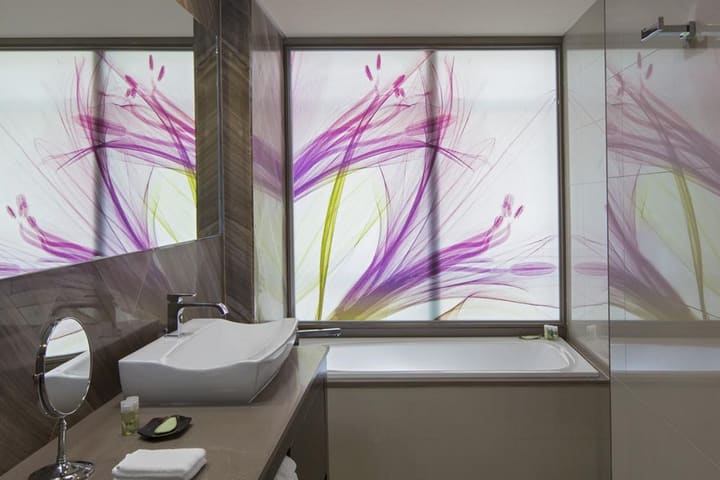 Guest bathroom with tub in a suite