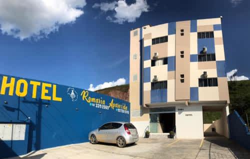 un coche aparcado en un aparcamiento frente a un hotel del Hotel Romaria Aparecida, en Aparecida