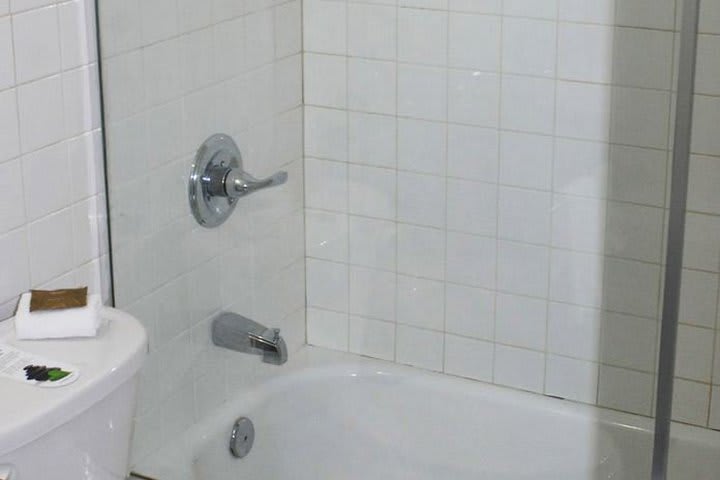 Bathroom with tub and shower at the Harrison South Beach hotel