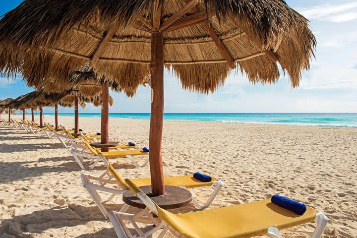 The beach area has sun loungers and shades