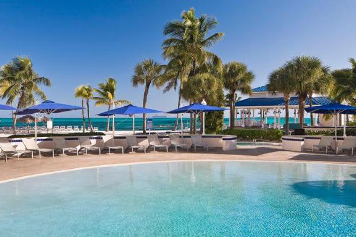 Piscina con camas de playa plegables