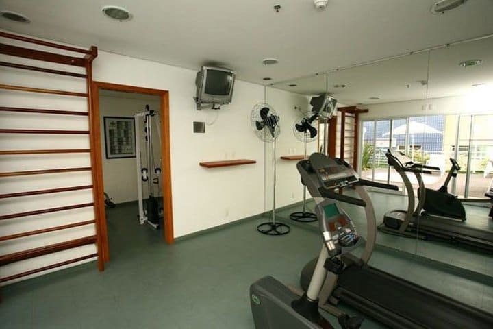 Fitness center with cardio equipment at the Saint Charbel Suites hotel in Sao Paulo