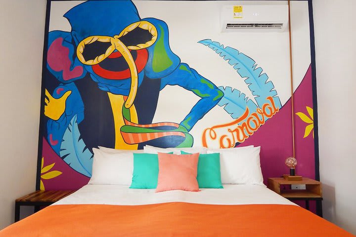 King guest room with decoration alluding to the culture of the Atlantic area such as the Barranquilla Carnival