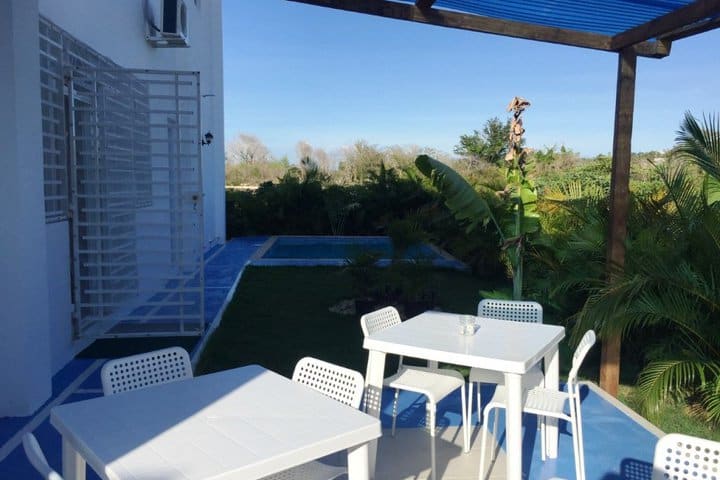 Tables and chairs next to the pool