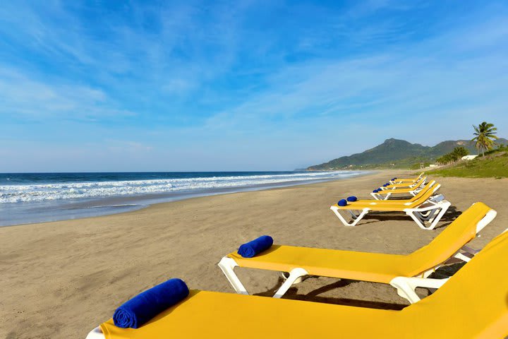 The beach has a sitting area and offers bar service