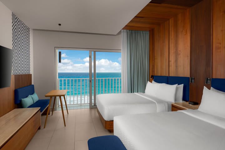 Beachfront guest room with 2 queen size beds  and Juliet-style balcony