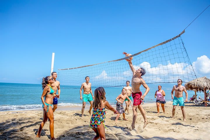 Play beach volleyball