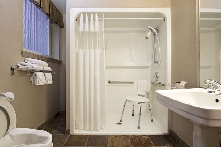 Guest bathroom fitted for guests with disabilities at the Ramada Limited Vancouver hotel