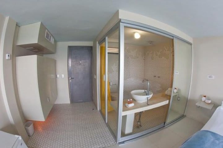 Bathroom with glass walls at Rocamar, hotel in Isla Mujeres