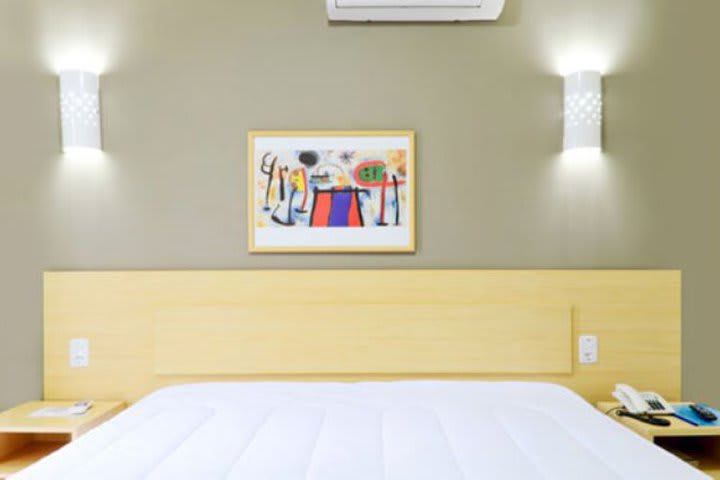 Guest room at Hotel Coral Tower Express in Porto Alegre with a double bed