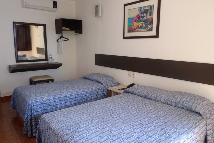 Standard guest room with a double and a single bed