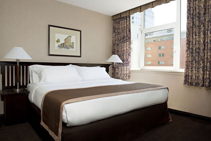 Guest room with king sized bed at the Ramada Limited Downtown Vancouver hotel