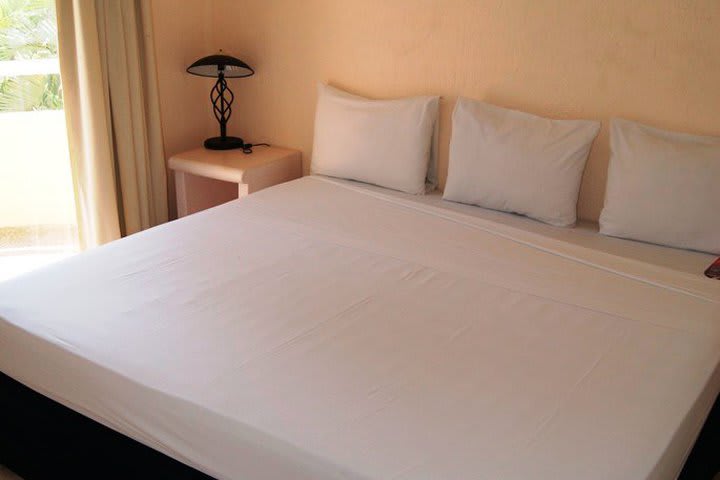 Guest room with a king bed at the Villamar Princesa Suites hotel in Acapulco