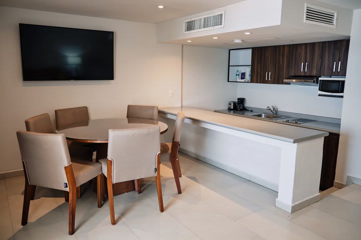 Dining area and kitchen of a junior suite with partial view