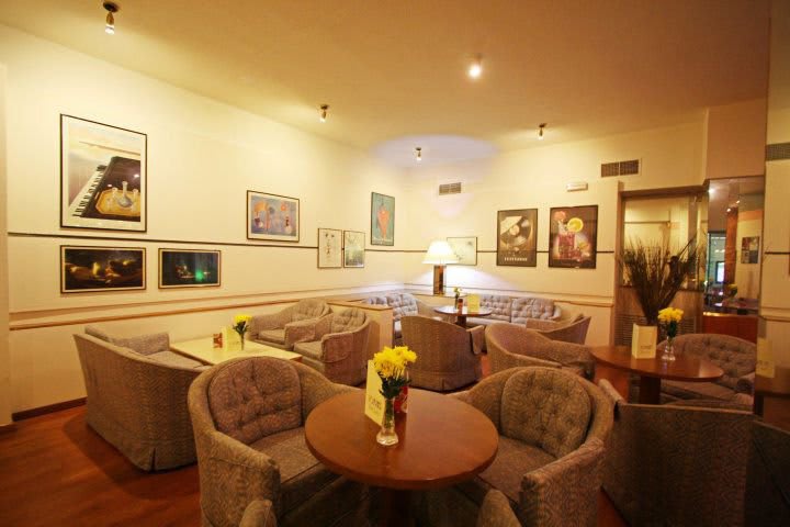 Arm chairs and tables in the bar at the Ionis hotel in Athens