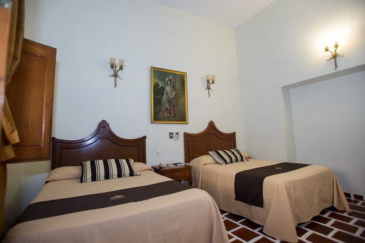 Guest room with two beds at Hotel Francés