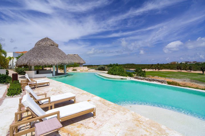 The pool is surrounded by sun loungers