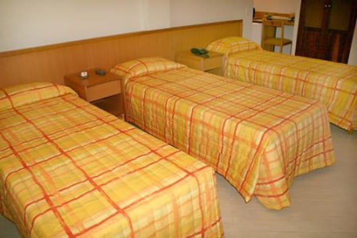 Standard guest room with three twin beds at the Arcos Rio Palace hotel