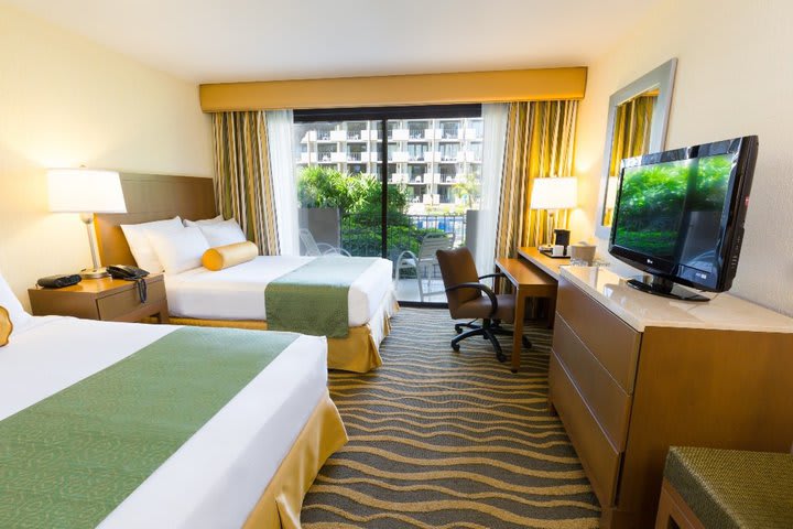 Guest room with balcony and pool view