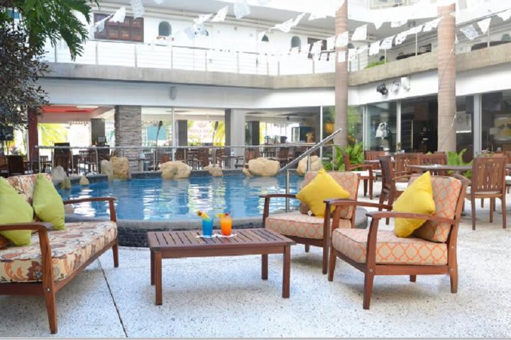 Tables and chairs by the pool