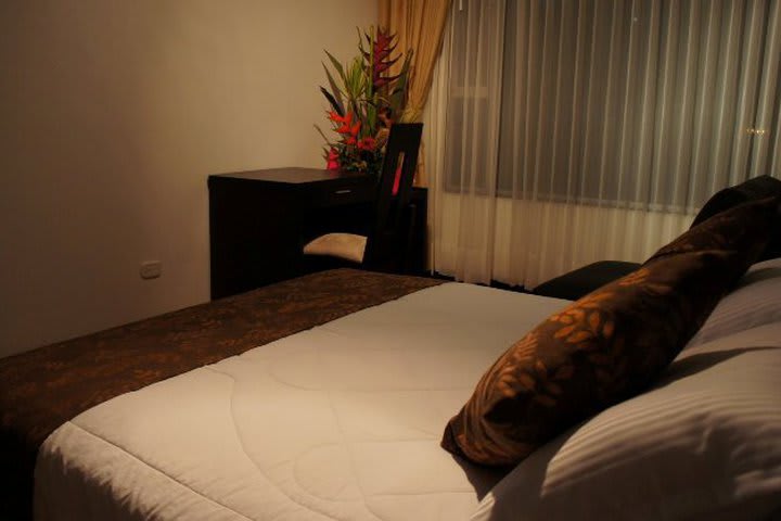 Guest rooms with wooden furniture at Santafe Real, hotel in Bogota