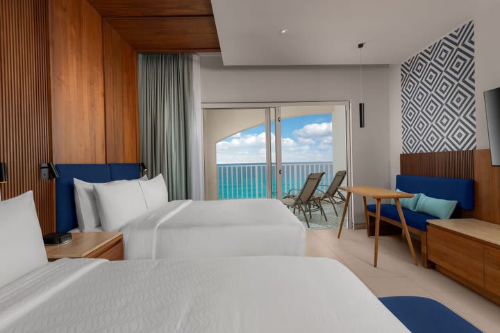 Beachfront guest room with two beds and large balcony