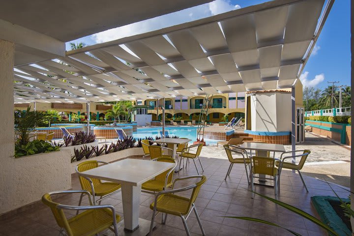 Tables on the terrace next to the pool