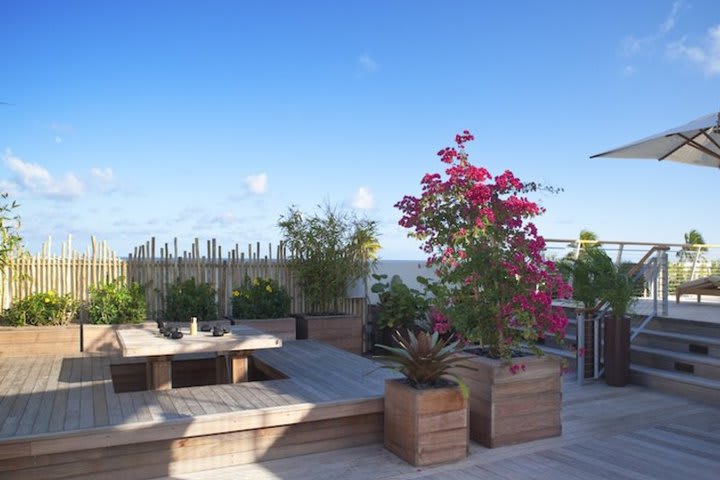 The terrace at The Betsy Hotel has wooden finishes