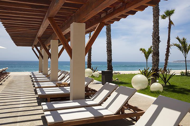 Solárium con camas de playa plegables en la piscina