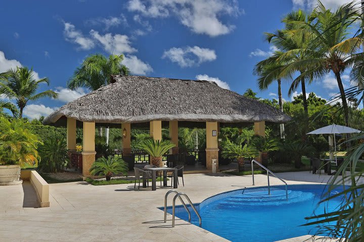 The pool area has tables and chairs