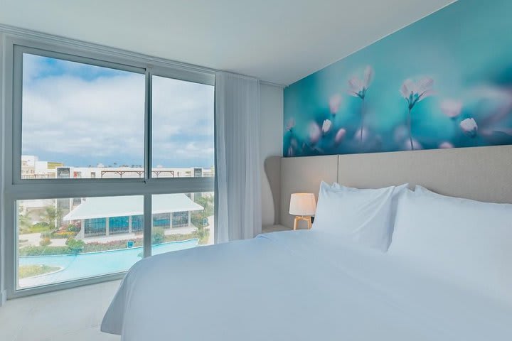 Bedroom of a suite with pool view