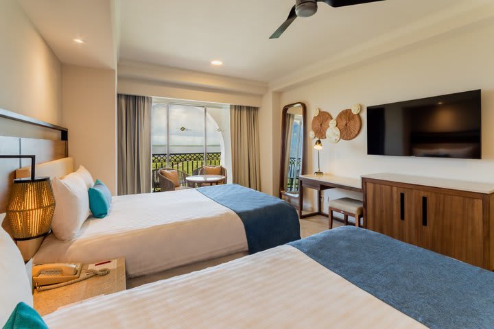 Guest room with two beds in front of the lagoon