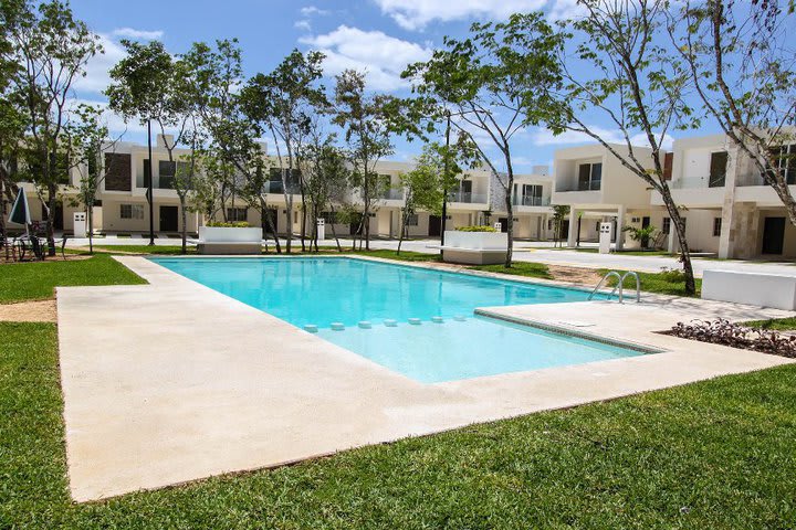 The pool is surrounded by green areas