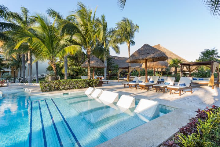 Sun loungers in front of the pool