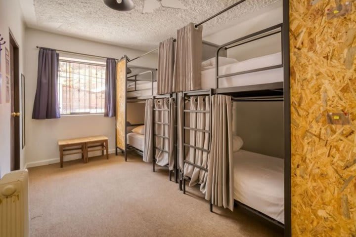 Bed in a community room with 4 beds