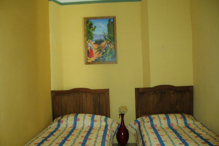 Guest room with single beds at Hotel del Peregrino in Merida