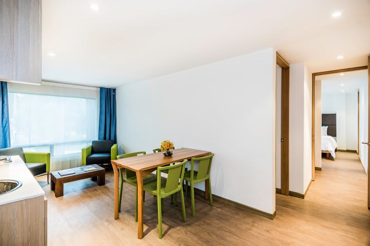 Sitting area, table, and chairs in an apartment