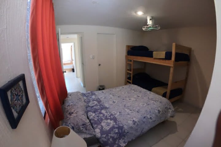 Accommodation with a double bed and a bunk bed