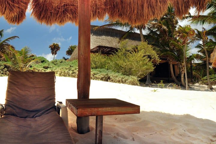 Sun loungers with shades on the beach area