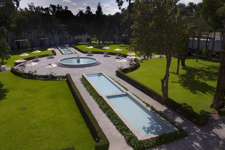 The hotel is surrounded by gardens and fountains