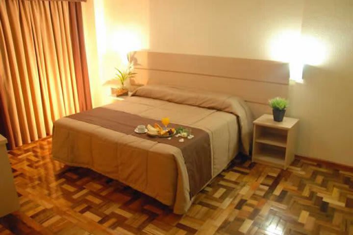 Guest rooms at the Umbu Hotel in Porto Alegre have wooden floors