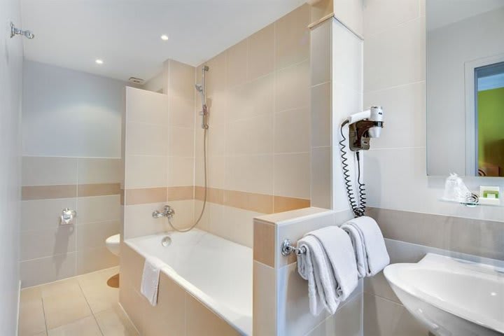 Some rooms at the Grand Hotel des Gobelins offer a private bathroom with tub