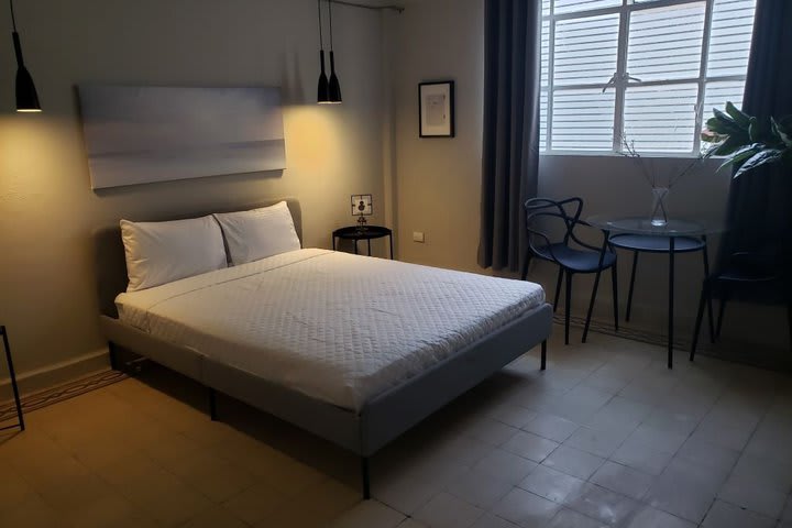 Guest room with a queen size bed and shared bathroom