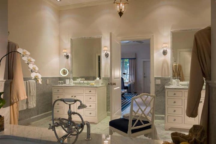 Bathroom with tub and double sink in a guest room at Fisher Island Club, luxury hotel on a private island