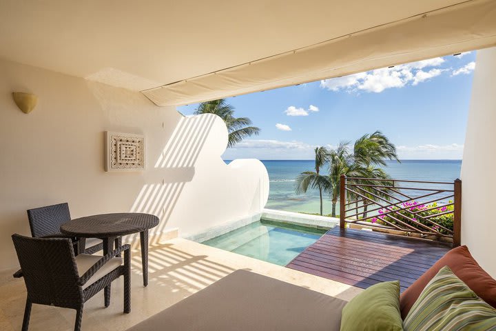 Bedroom of an Ambassador suite with pool and ocean view