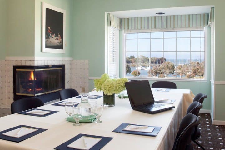 The boardroom at The Inn at Oyster Point has a fireplace