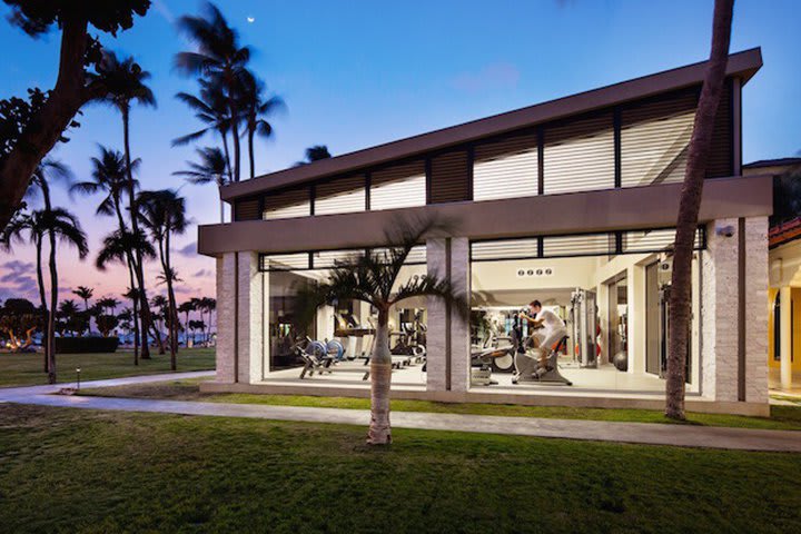 Fitness center with large windows overlooking the garden