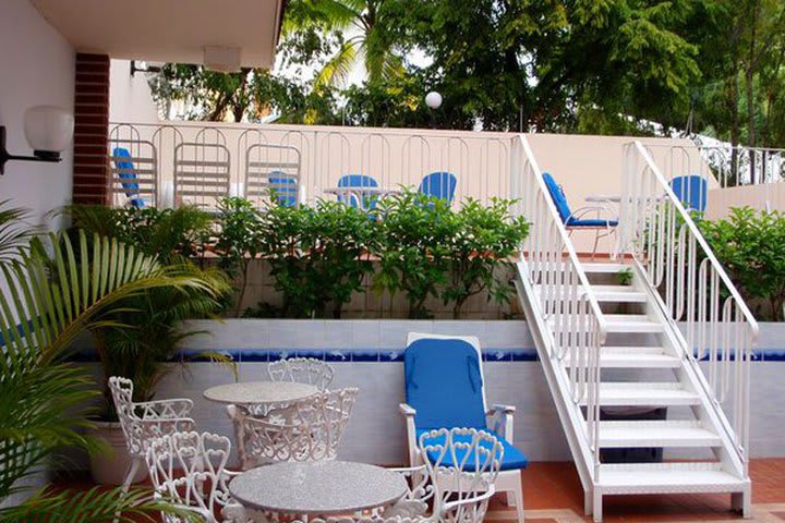 Tables, chairs, and sun loungers in the pool area