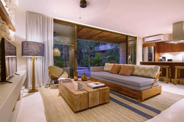 Sitting area in a suite with private pool and jungle view